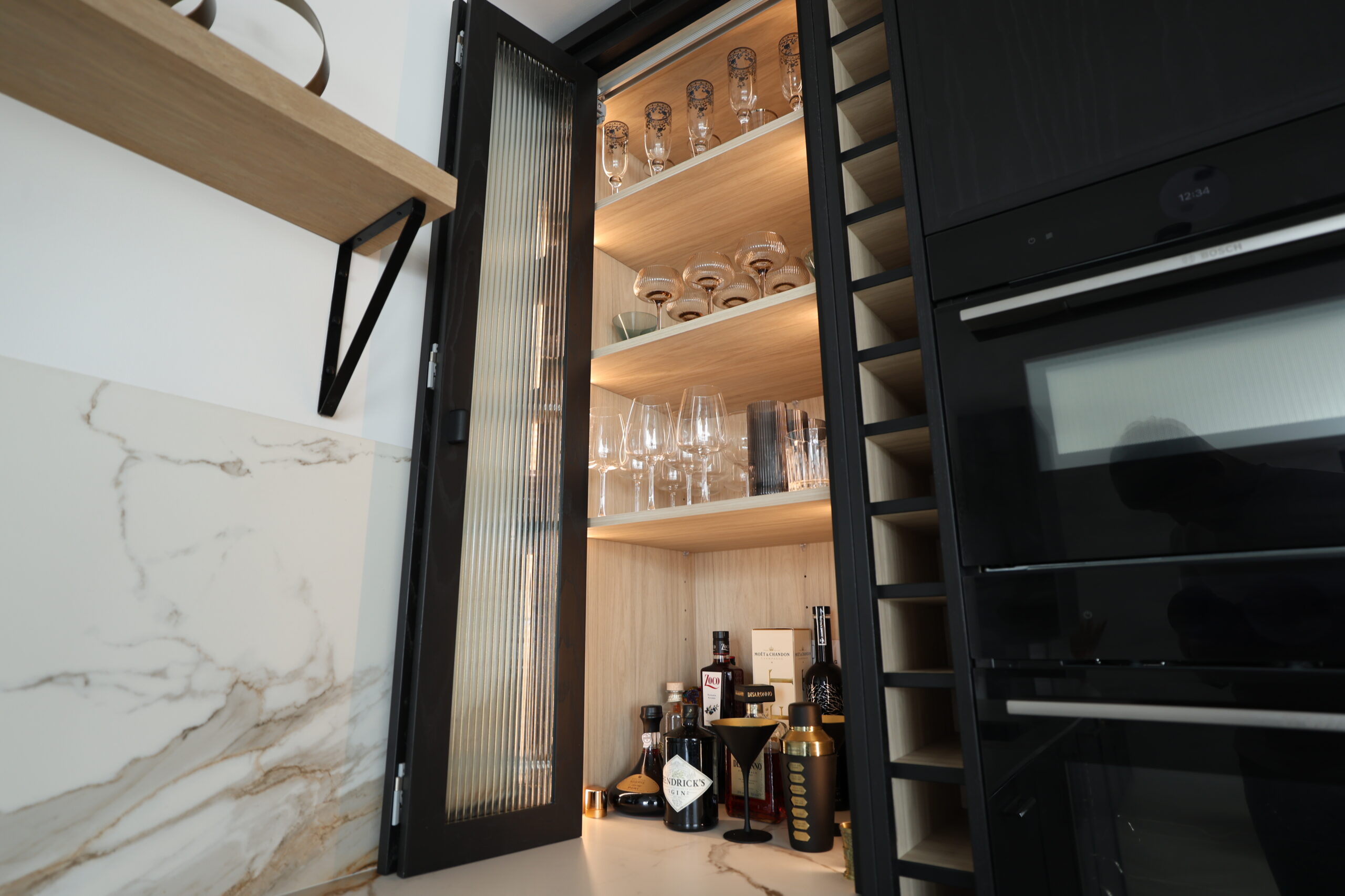 Custom wine wall with glazed display and timber feature joinery