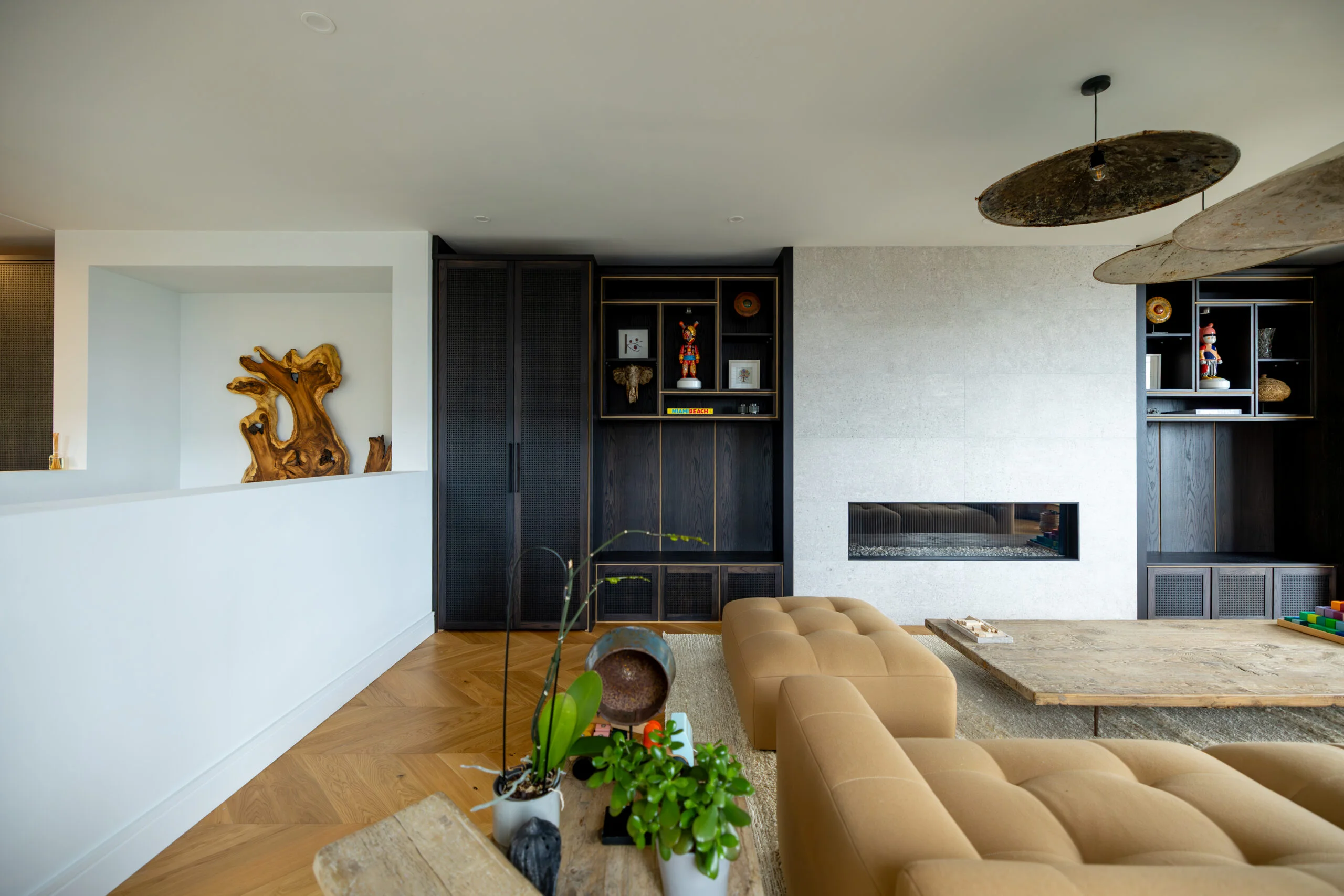 Living room showcasing black cabinets-white fire wall